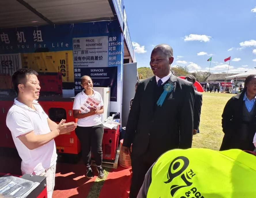 Visitors and SEER POWER staff discussing agricultural power applications.